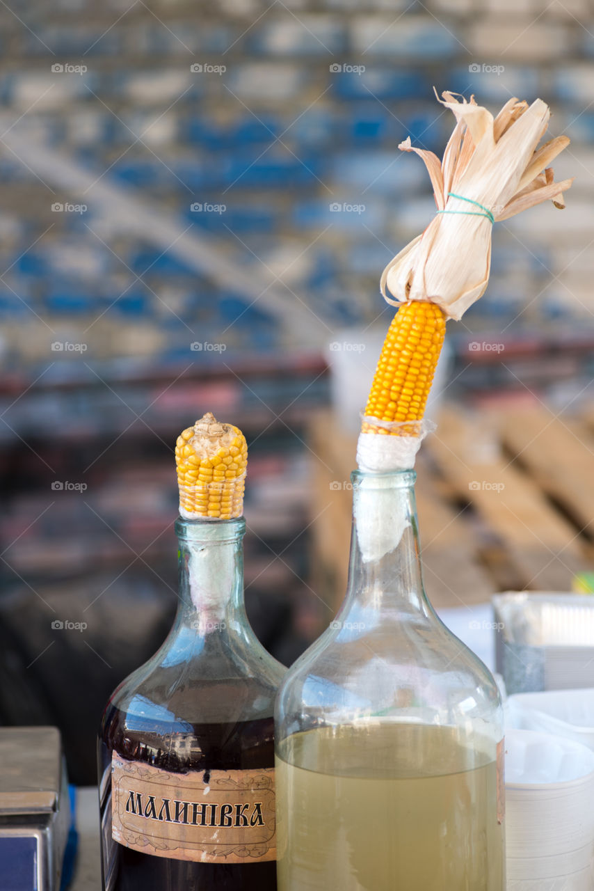 Bottles with moonshine and liqueur  at street food festival