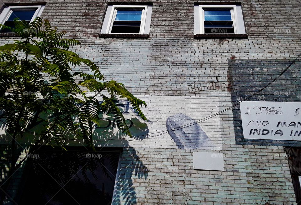 Old painted signs fading on the back of a building