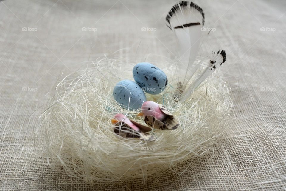 Easter spring holiday decorative birds with eggs in nest