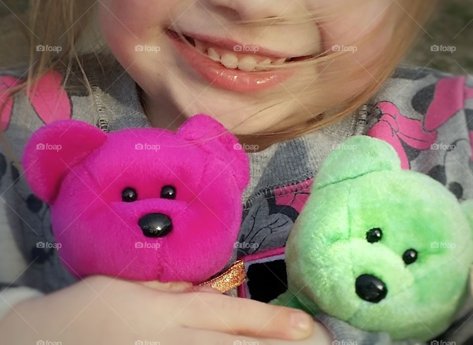 It makes me happy to see a child happy and enjoying life with her sweet smile and colorful teddy bears! :)