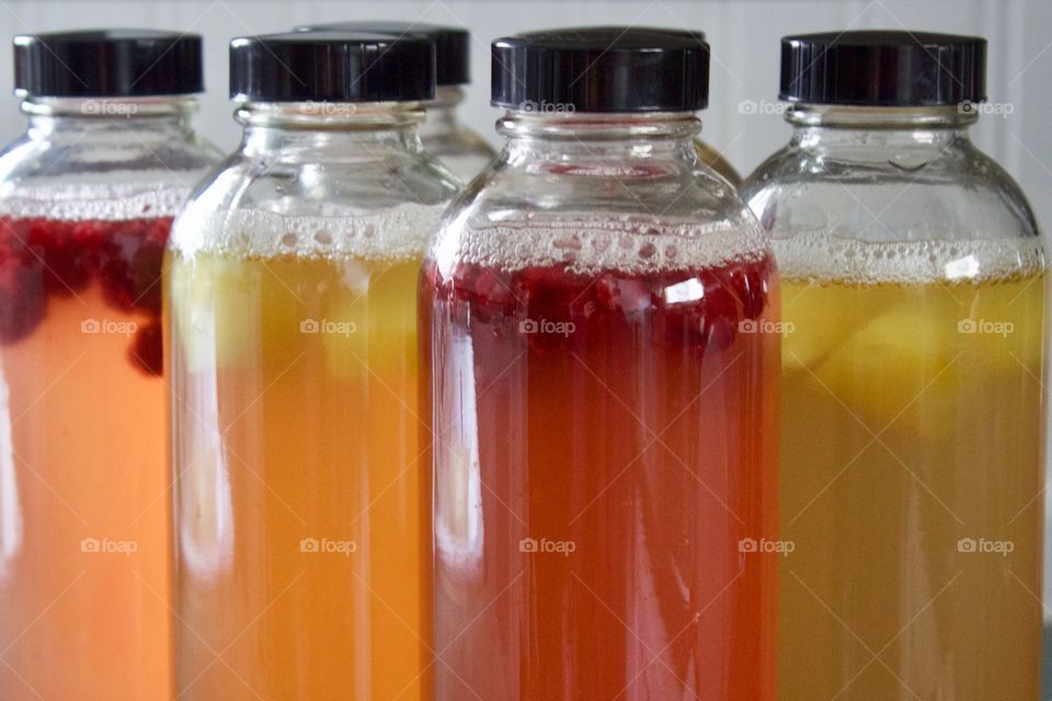 Raspberry- and pineapple-infused, home-brewed kombucha in bottles for flavorings and a second ferment - - a different kind of bubbly! 