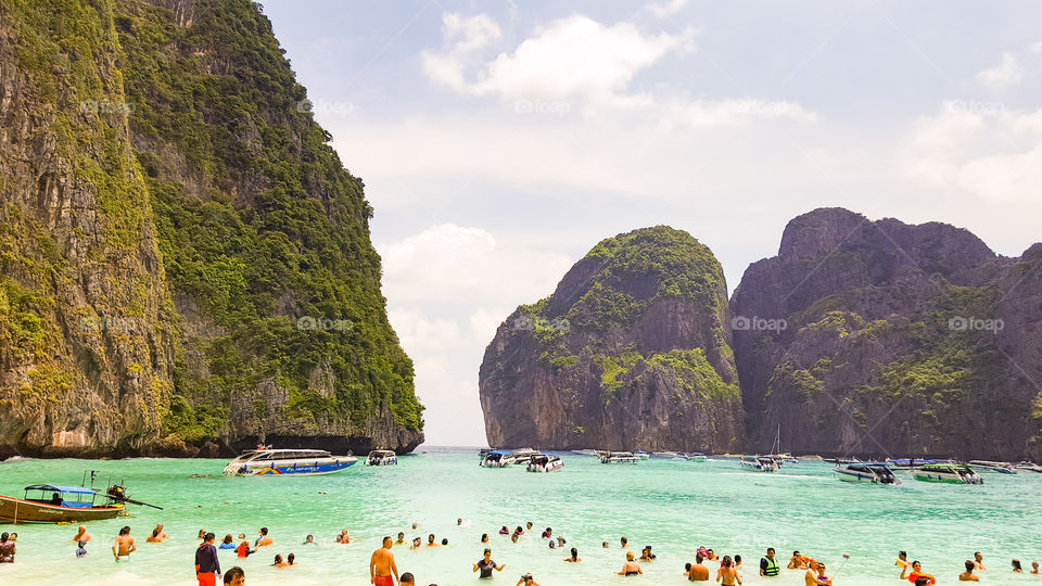 Maya bay. Phi Phi (also known as Koh Phi Phi, Thai: หมู่ เกาะ พี พี) is a small archipelago located in the Andaman Sea, south of Thailand. It has become in recent years a very popular place for tourism, to the point that the expansion of hotel infrastructures are growing uncontrollably to accommodate so much tourism demand. The Phi Phi Islands (Thai: หมู่ เกาะ พี พี, rtgs: Mu Ko Phiphi, pronounced [mːː kɔʔ pʰīː.pʰīː]) are an island group in Thailand, between the large island of Phuket and the west Strait of Malacca coast of the mainland . The islands are administratively part of Krabi province. Ko Phi Phi Don ("ko" (Thai: เกาะ) meaning "island" in the Thai language) is the largest island of the group, and is the most populated island of the group, although the beaches of the second largest island, Ko Phi Phi Lee (or "Ko Phi Phi Leh"), are visited by many people as well. The rest of the islands in the group, including Bida Nok, Bida Noi, and Bamboo Island (Ko Mai Phai), are not much more than large limestone rocks jutting out of the sea. The Islands are reachable by speedboats or Long-tail boats most often from Krabi Town or from various piers in Phuket Province. The Phi Phi Islands (Thai: หมู่ เกาะ พี พี, rtgs: Mu Ko Phiphi, pronounced [mːː kɔʔ pʰīː.pʰīː]) are an island group in Thailand, between the large island of Phuket and the west Strait of Malacca coast of the mainland . The islands are administratively part of Krabi province. Ko Phi Phi Don ("ko" (Thai: เกาะ) meaning "island" in the Thai language) is the largest island of the group, and is the most populated island of the group, although the beaches of the second largest island, Ko Phi Phi Lee (or "Ko Phi Phi Leh"), are visited by many people as well. The rest of the islands in the group, including Bida Nok, Bida Noi, and Bamboo Island (Ko Mai Phai), are not much more than large limestone rocks jutting out of the sea. The Islands are reachable by speedboats or Long-tail boats most often from Krabi Town.