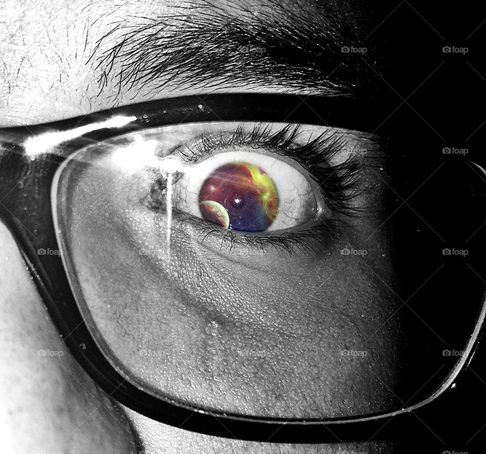 Colorful eyeball seen through eyeglasses