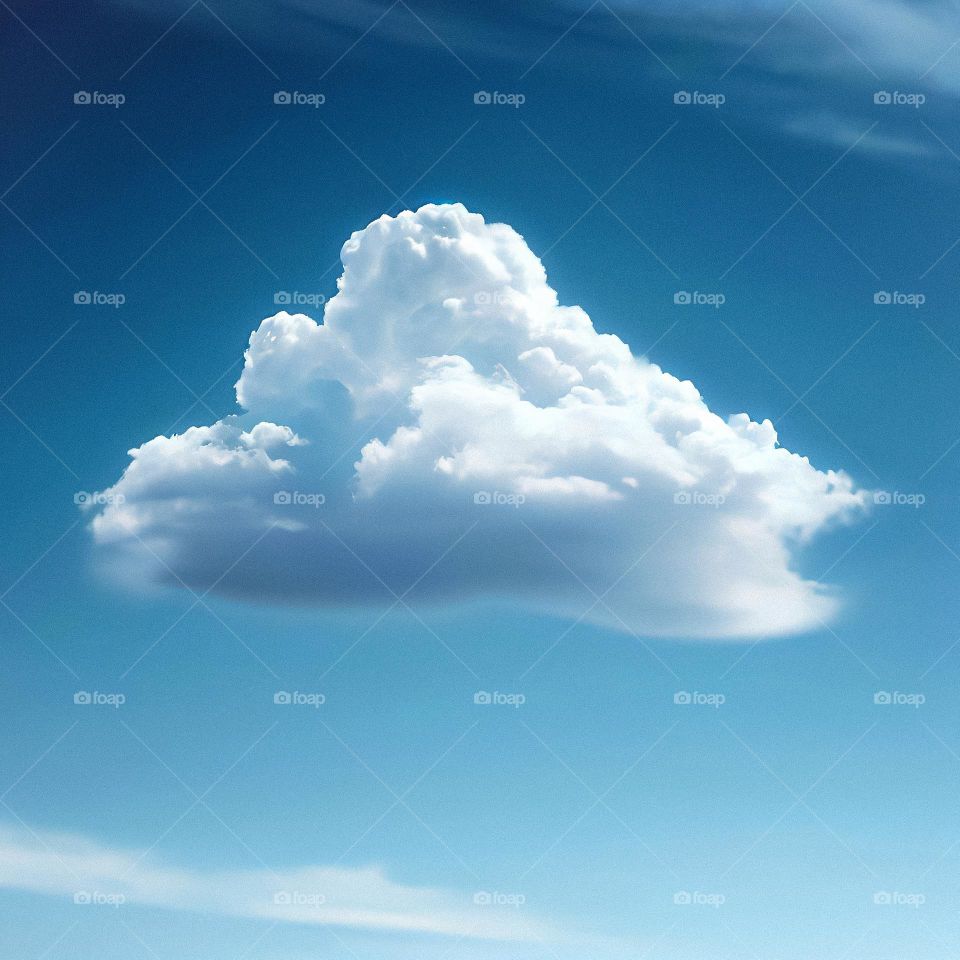 A single cloud in a blue blue sky
