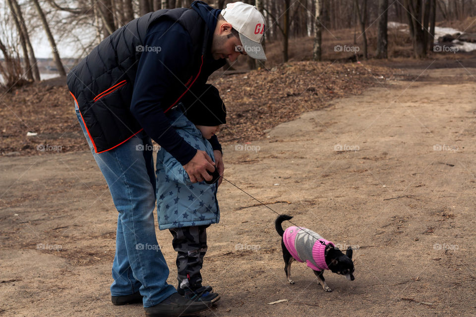 dad and son walk the dog