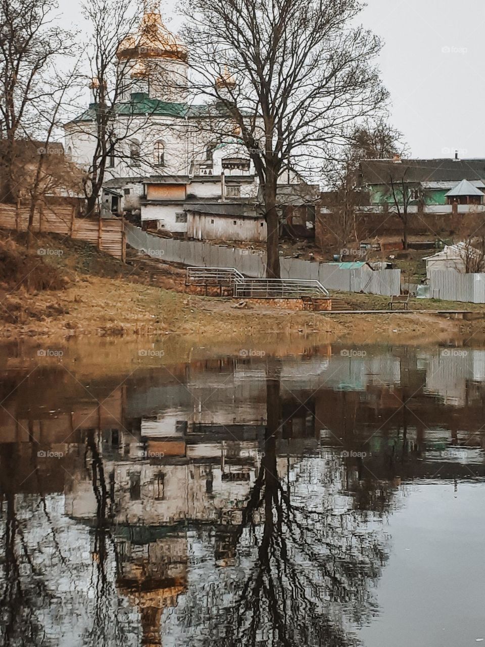 Reflection of the church in the spring river