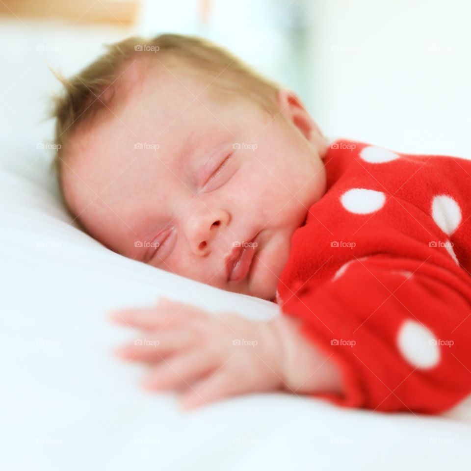 Baby sleeping on bed