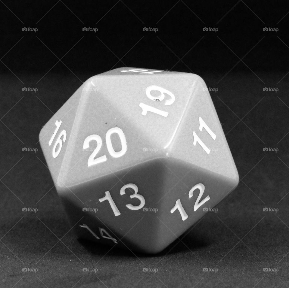 A green D20 countdown die in black and white