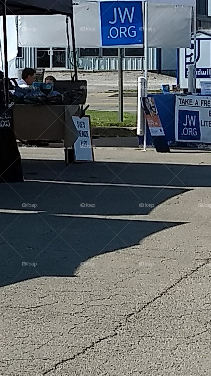 Jehovah's witnesses booth at a farmers market.