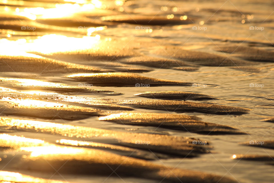 Sun rays reflected on sand