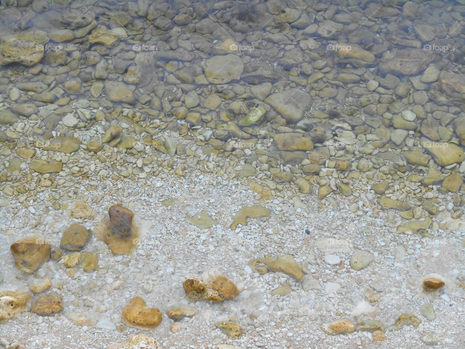 sea stones in clear water