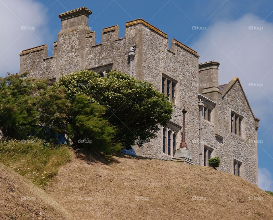 Part of the Dover Castle on a hill in England on a summer day. 