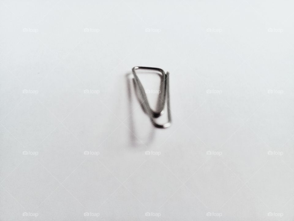 paper clip.This clip model is very widley used for paper files that are few in number simple shape made of metal