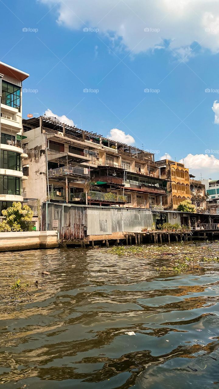 Run down buildings backing on to a river in Bankok 