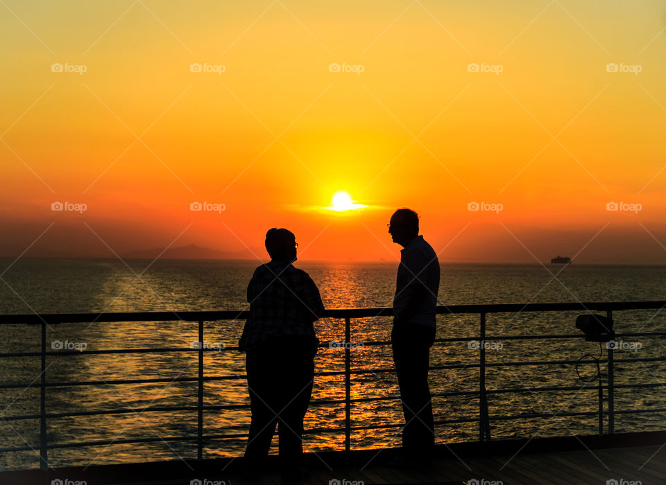 Silhouette Couple at sunset. Silhouette Couple at sunset during golden hour on cruise ship At mediterranean sea. 