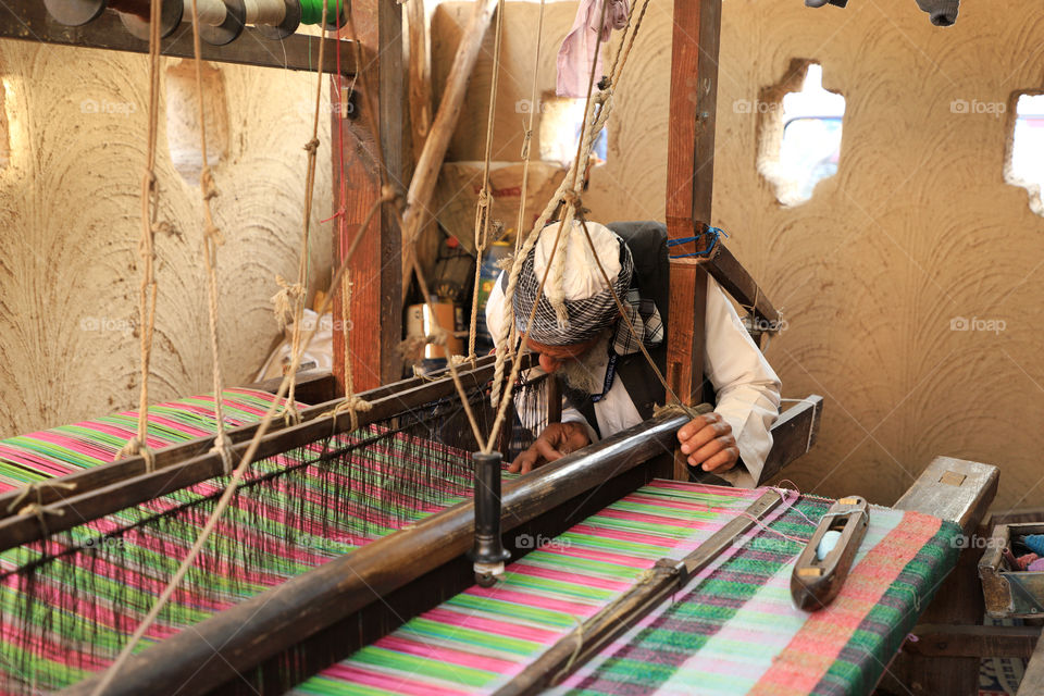 A traditional Indian carpet weaver