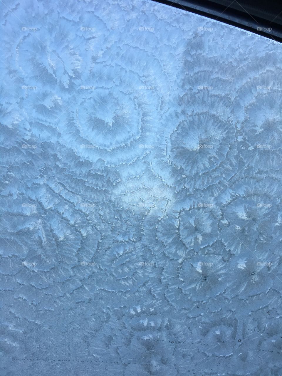 Ice on my cars window, on a freezing cold winters morning.