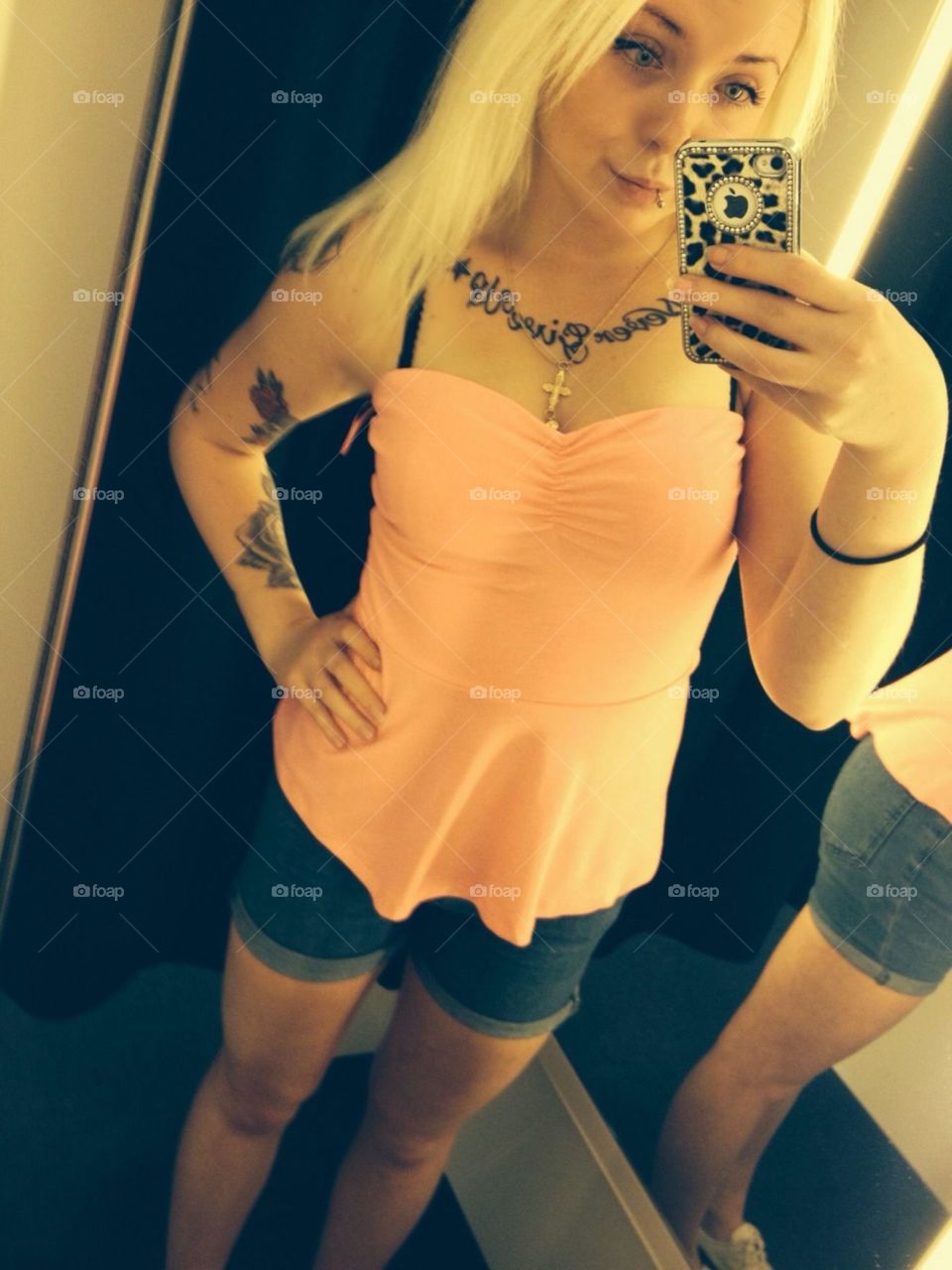 Stylish woman taking selfie from mirror