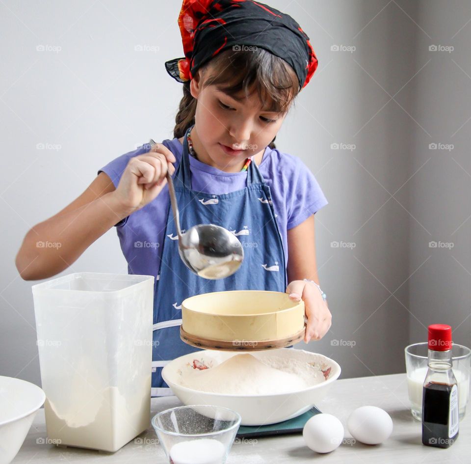 Cute girl is cooking bread