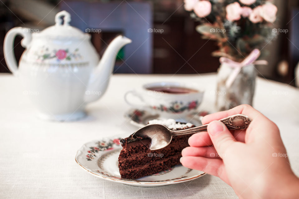 girl eating cake and drinking tea