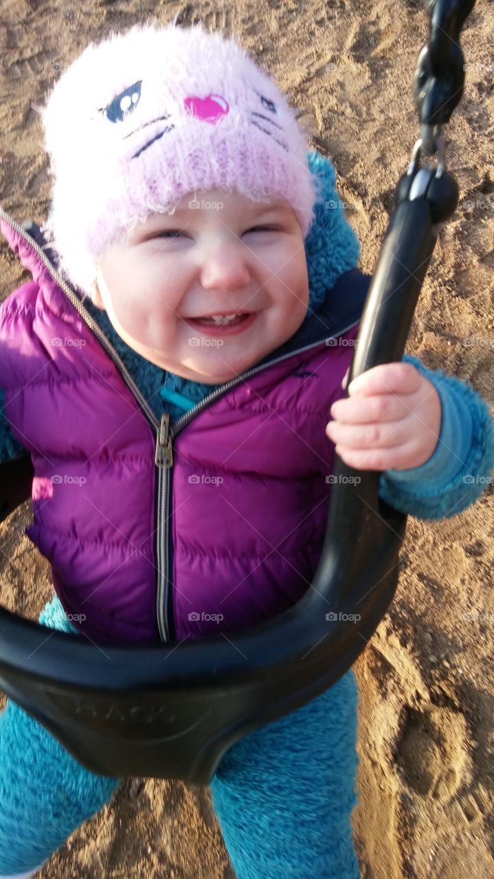 Portrait of a baby smiling on swing