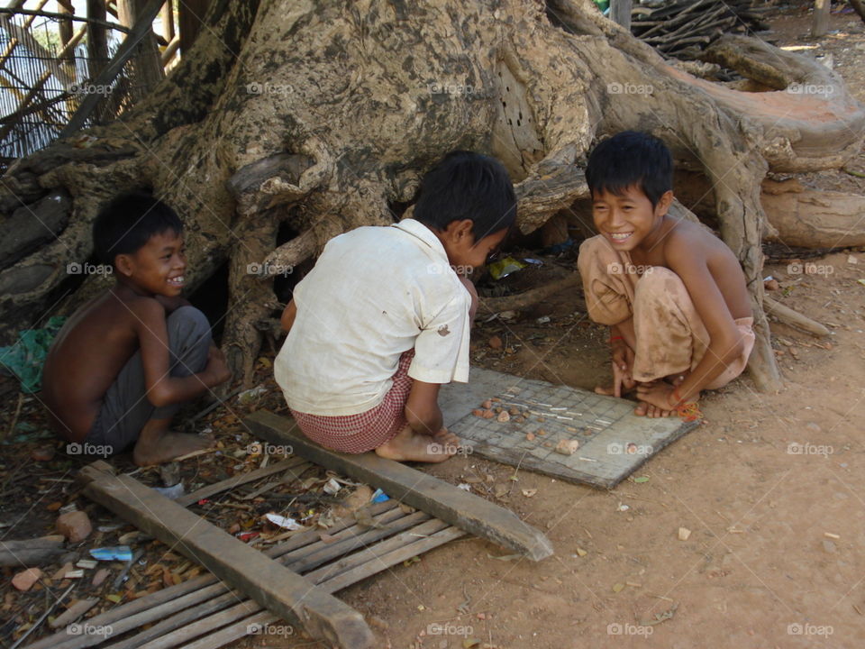 Boys playing game under the tree