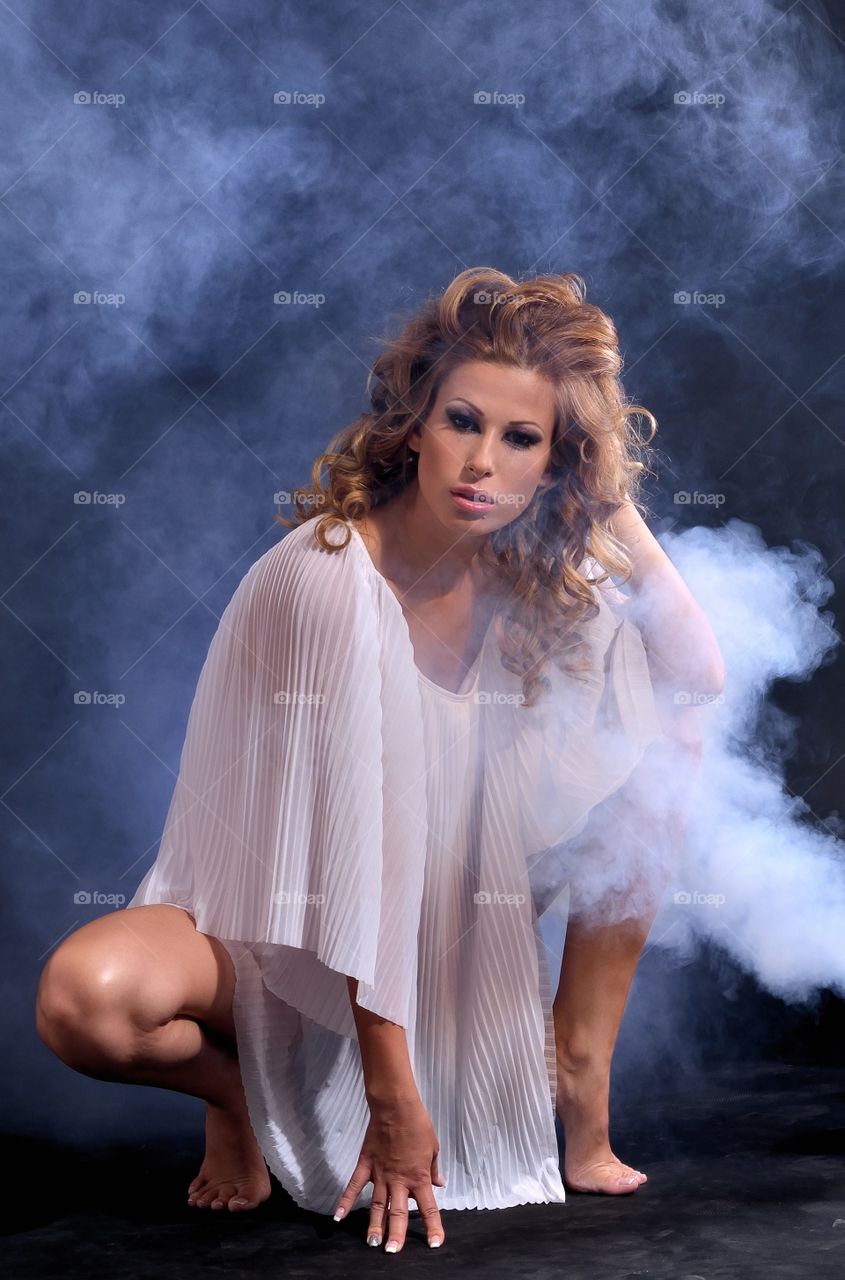 Young woman posing in smoky background