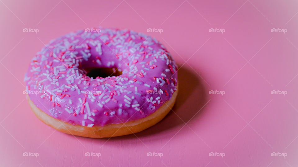 Pink donut on the pink background 