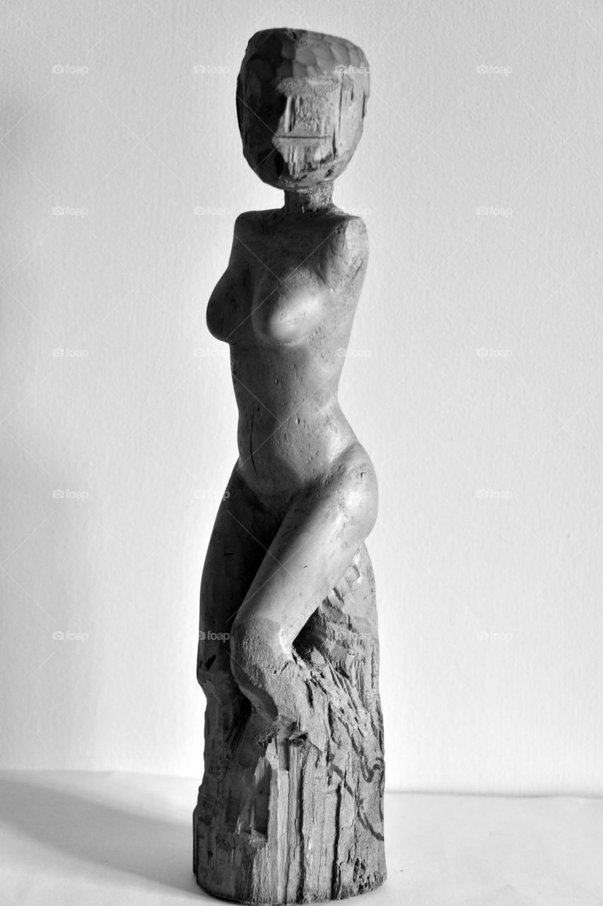 naked body of a woman, wood carving