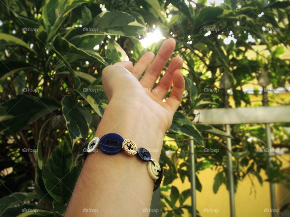 A sunny day at the garden. The bracelet in the picture was made by myself. 