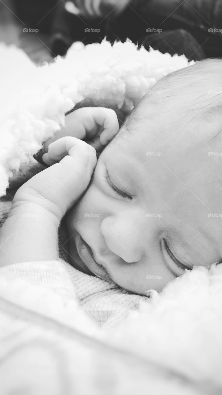 Cute baby boy sleeping on bed