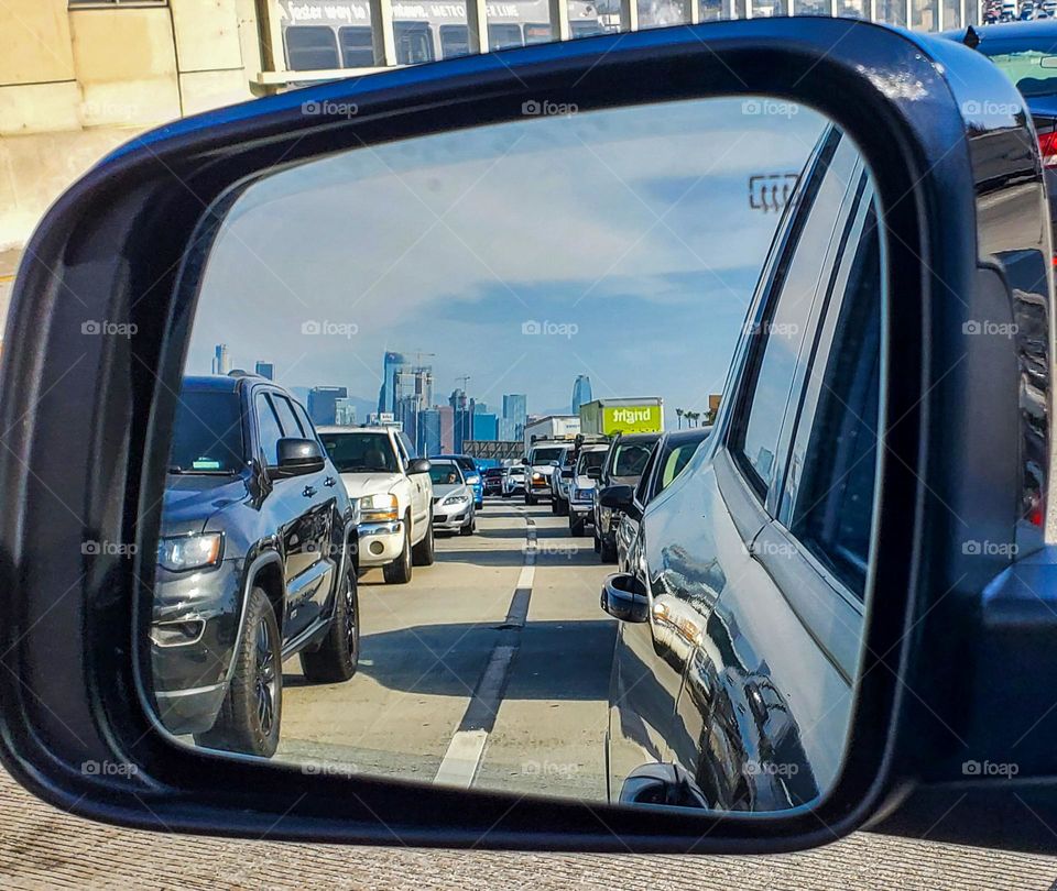Driving south on the 110 freeway with a view of downtown Los Angeles in my rear view mirror
