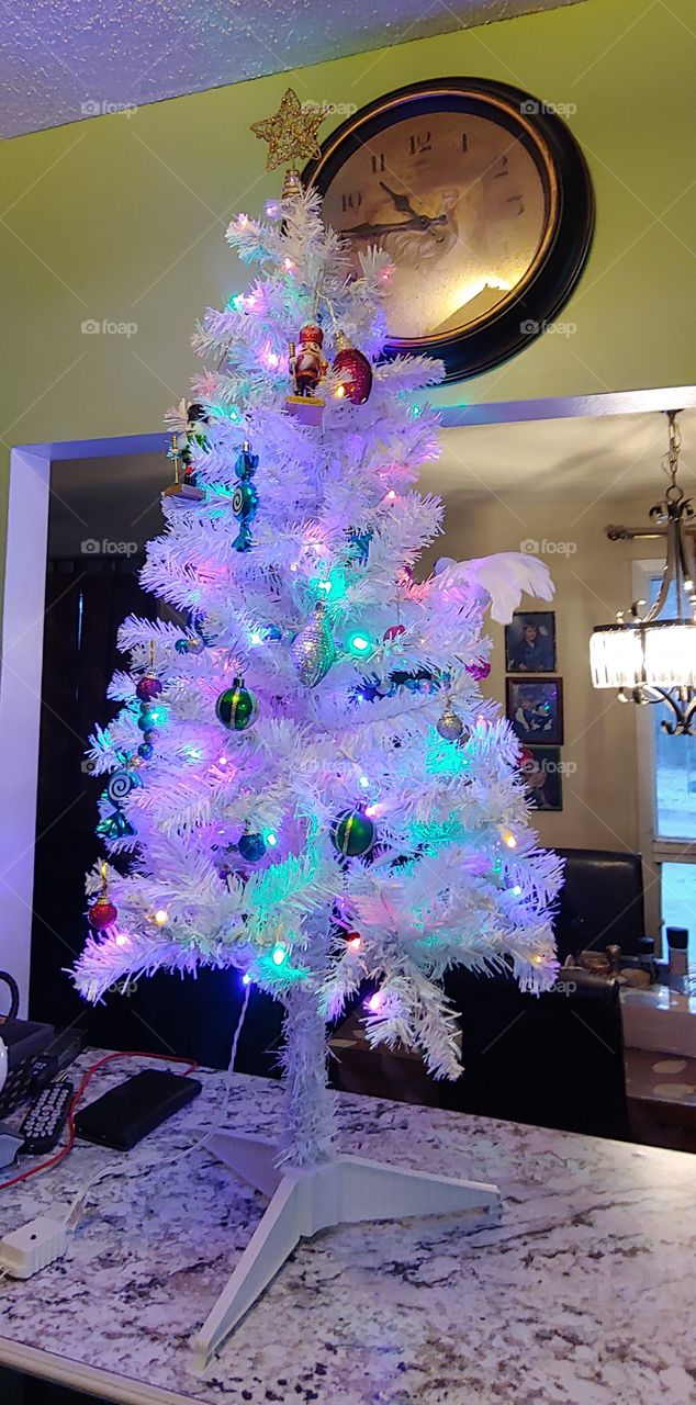 A small white Christmas tree with beautiful colorful light