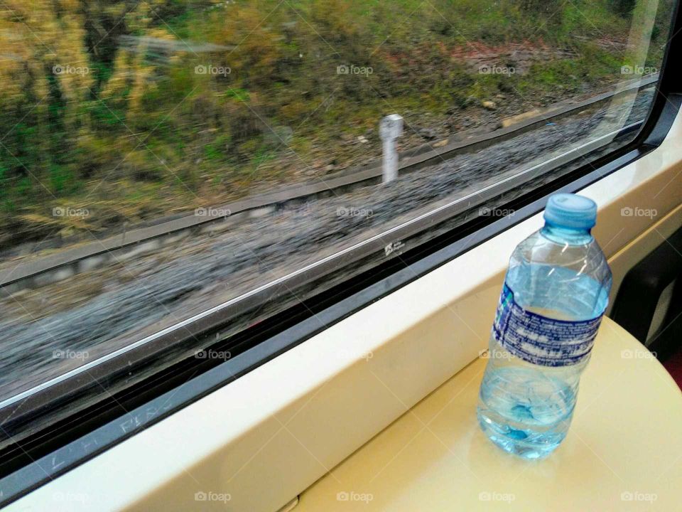 A bottle against a train window