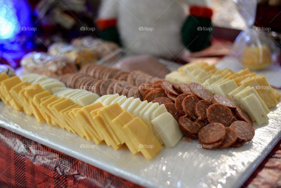 Variety of tasty cheeses and meats on a board