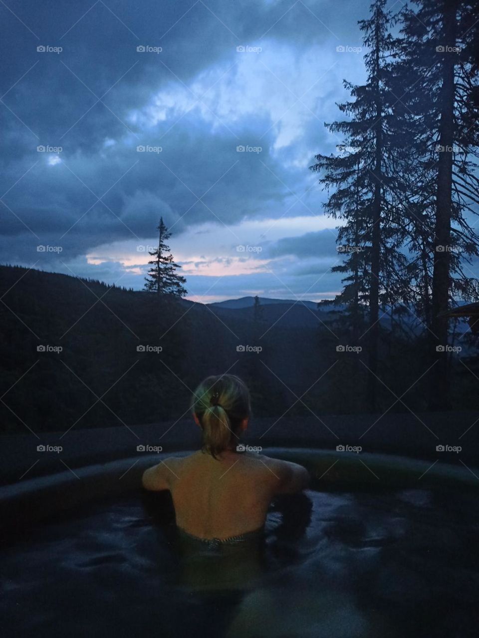 The stillness within . 
girl in meditation. Carpathians, vat, relaxation in a vat