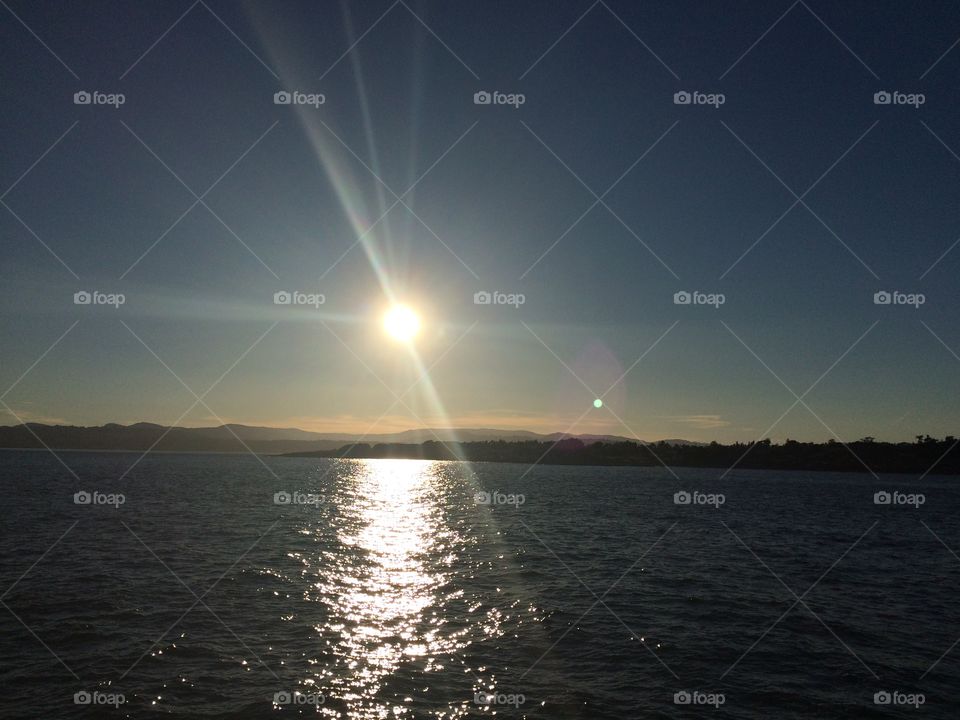 Glassy ocean and rays above