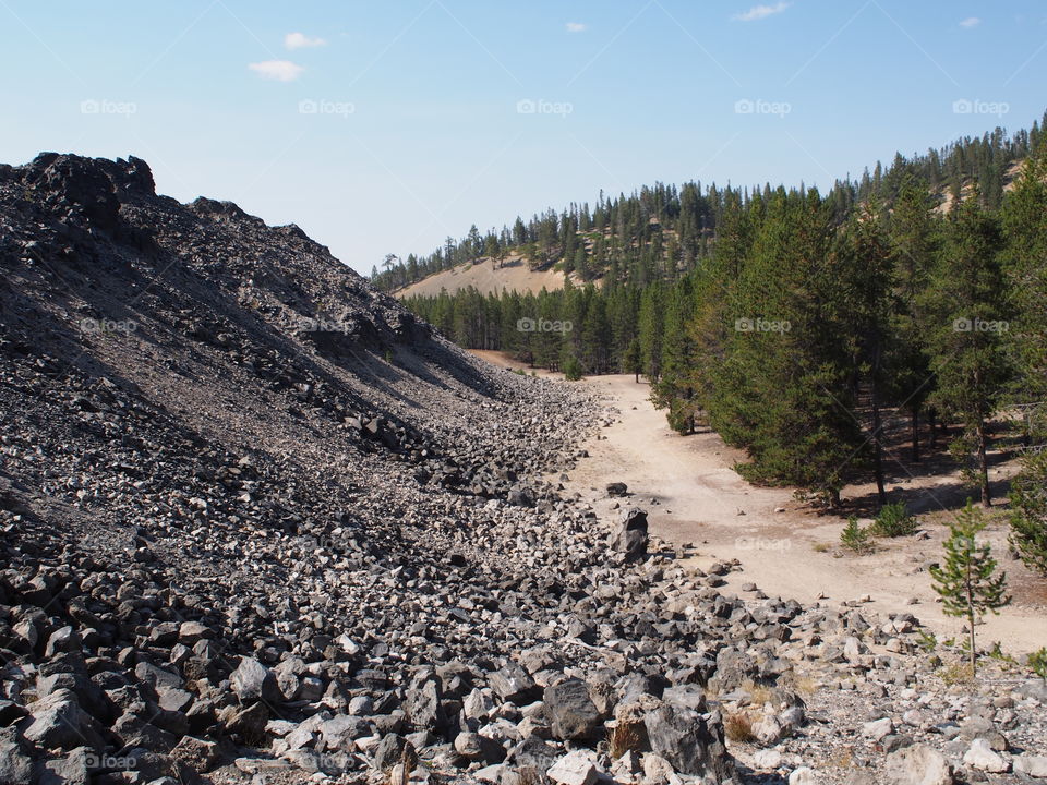 Textured Obsidian and hardened lava rock on a sunny fall day at the Big Obsidian Flow in the Newberry National Volcanic Monument in Central Oregon. 