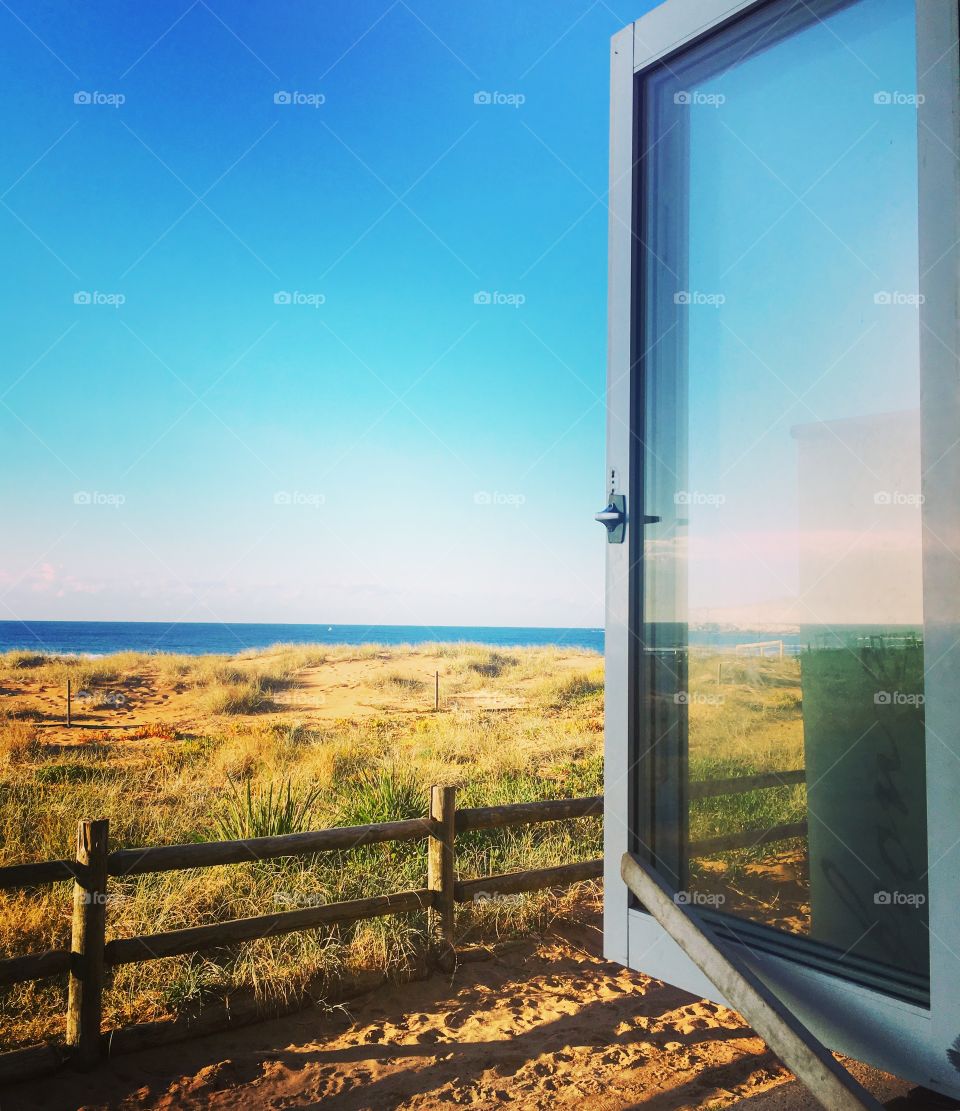 Looking at the beach through an open window 