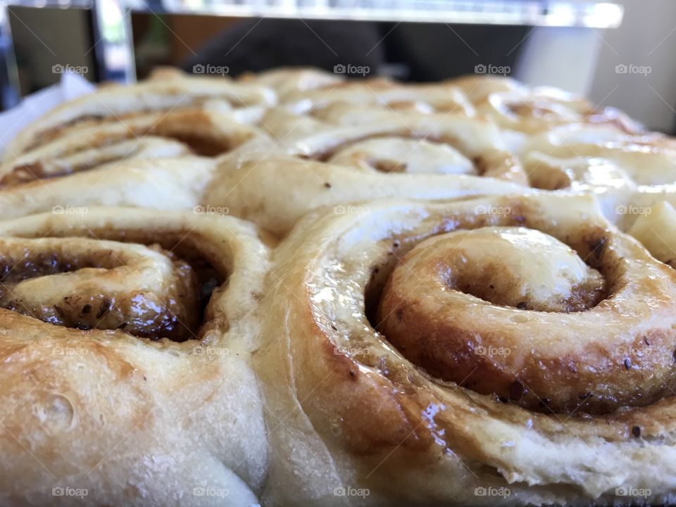 Perspective view cinnamon rolls scrolls on baking pan fresh out of oven