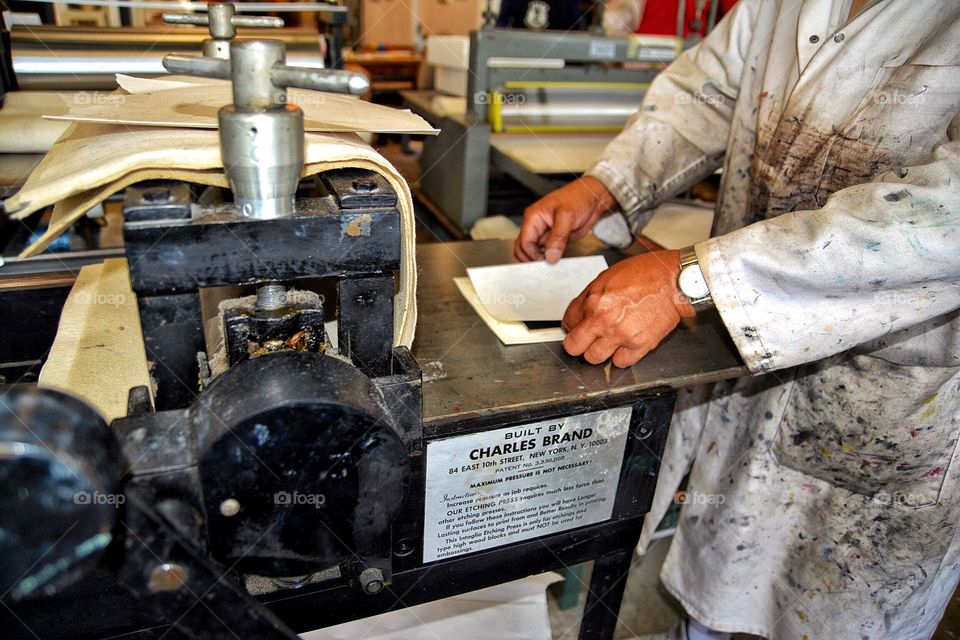 Man making ink block prints