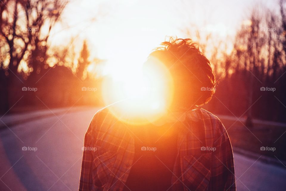 Beam of light by the side of a young man