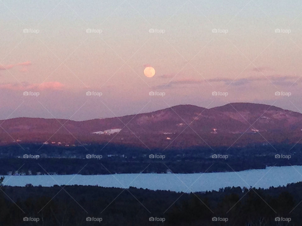 Moon rising over a mountainous Lakeview