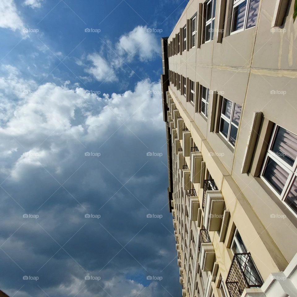 the view of the building and the blue sky, visible from below