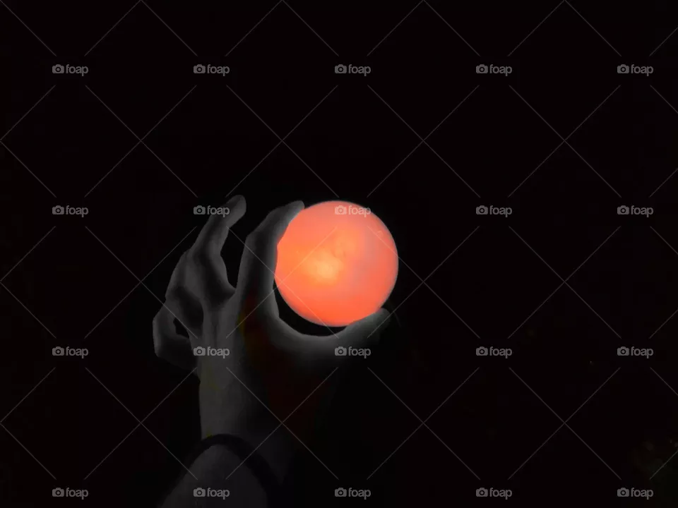 Red moon, sun, the illusion of it is a hand on the heart