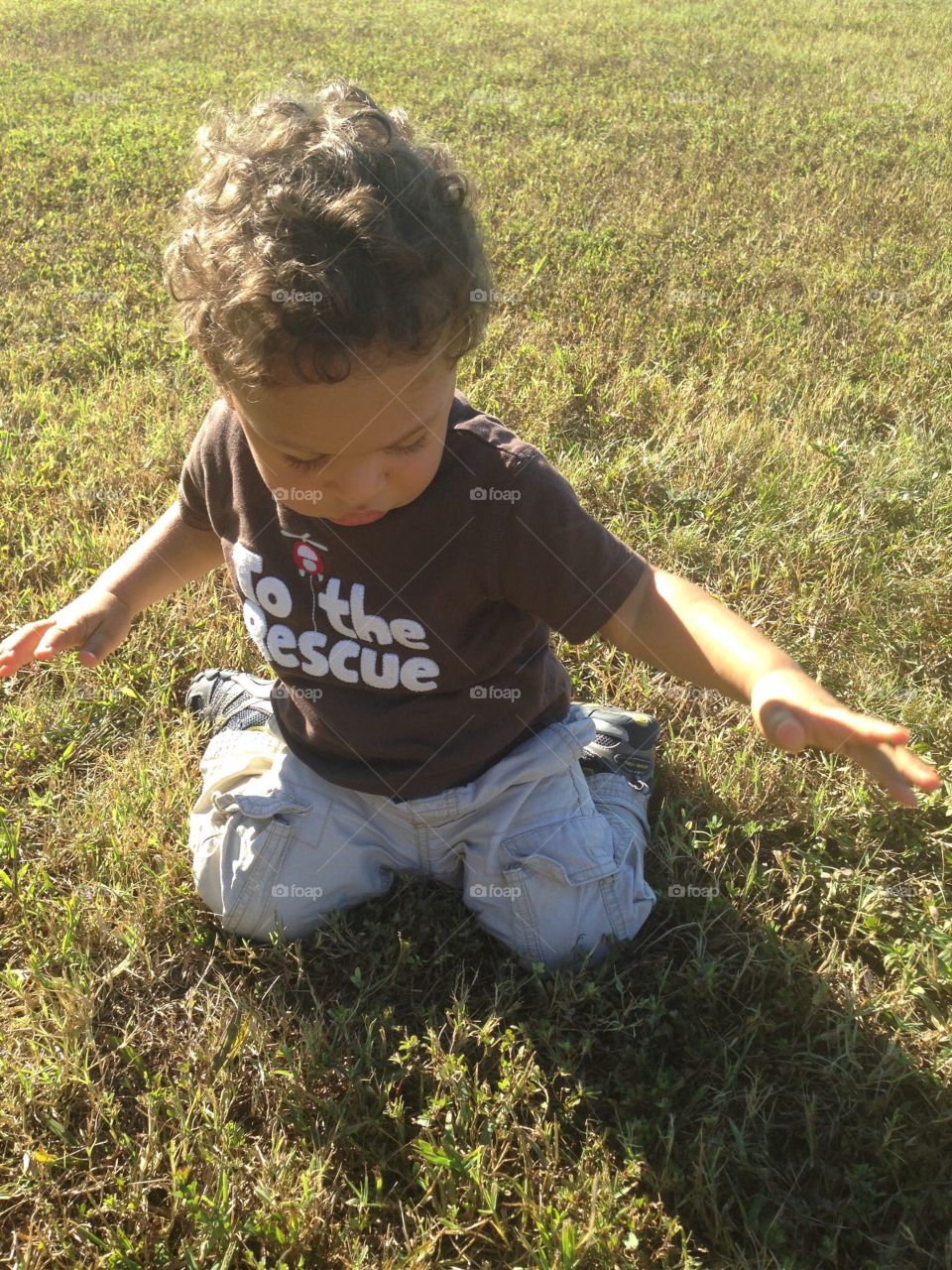 Boy playing in the grass 