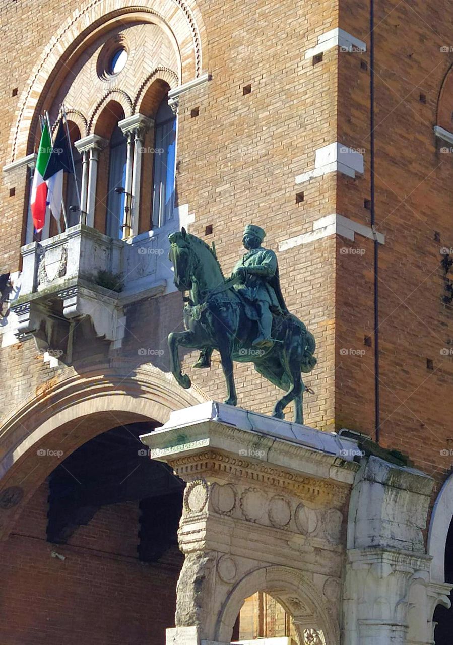 Metal.  Italy.  City of Ferrara: Palazzo Ducale and Camerino delle Duchess.  On one side of the entrance to the palace is a metal statue of the Marquise Niccolò III on horseback.