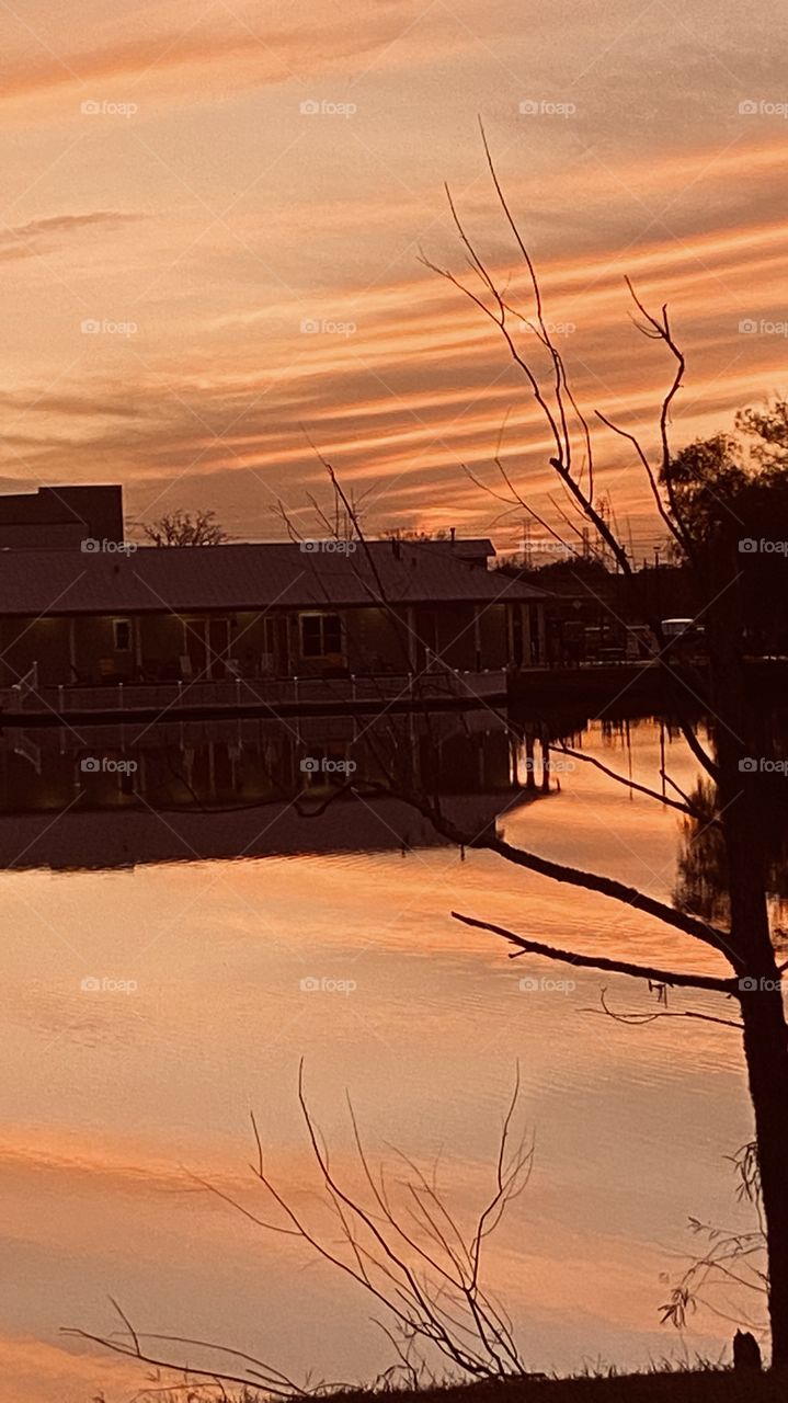 As the evening progresses the sun has now gone behind the high clouds and some colors are being cast over the lake waters with refections in the sky and on the waters.