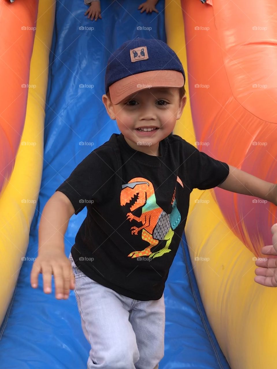 Child on a jumpy house slide