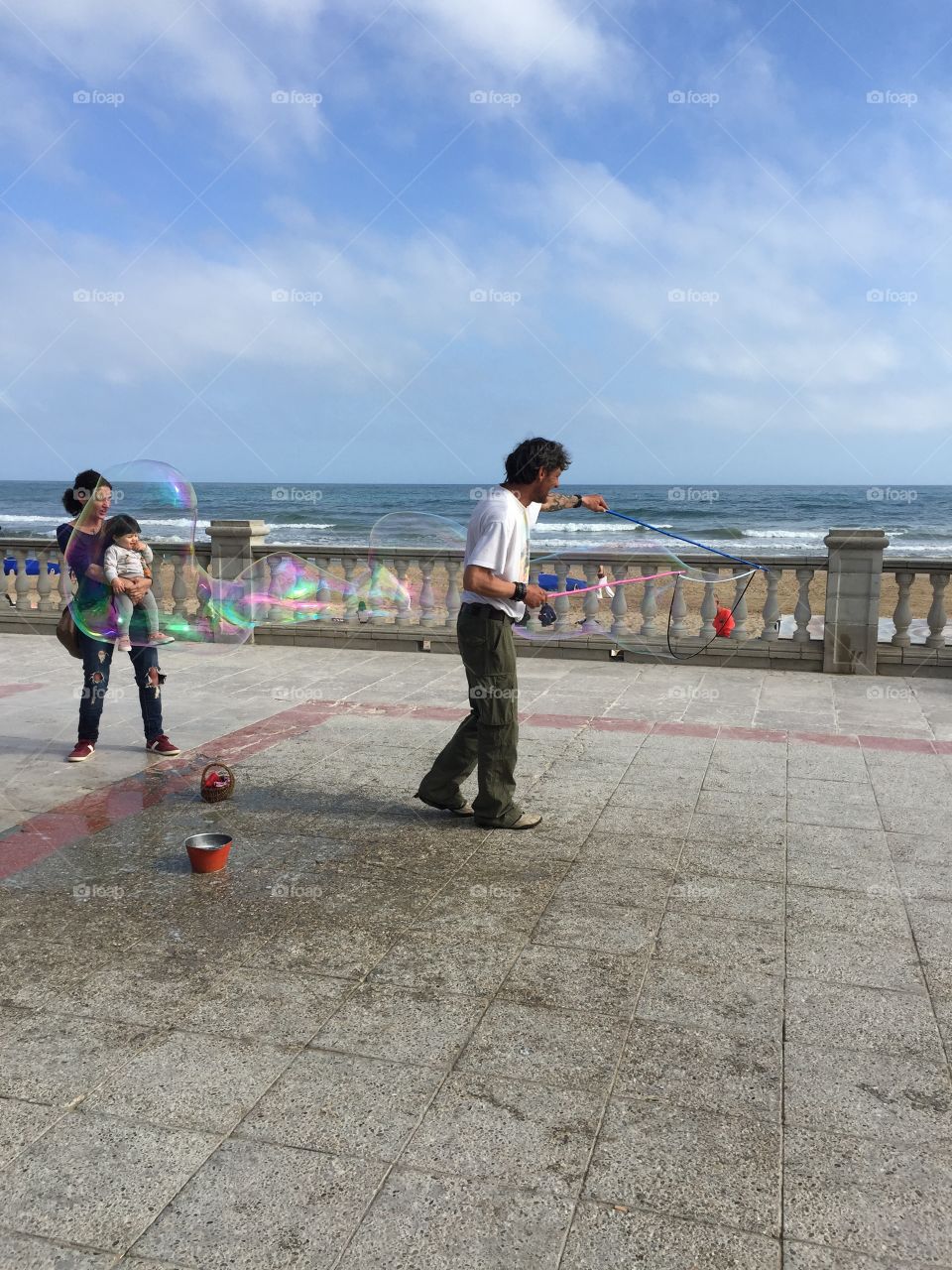 Street artist making soap bubbles at the boulevard of Sitges